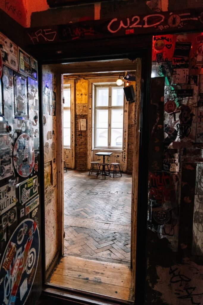 Open doorway leading into an atmospheric bar in Budapest, Hungary.