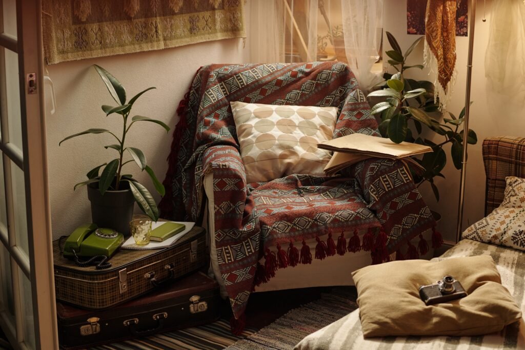 Vintage reading nook with armchair, patterned cushions and nostalgic decor