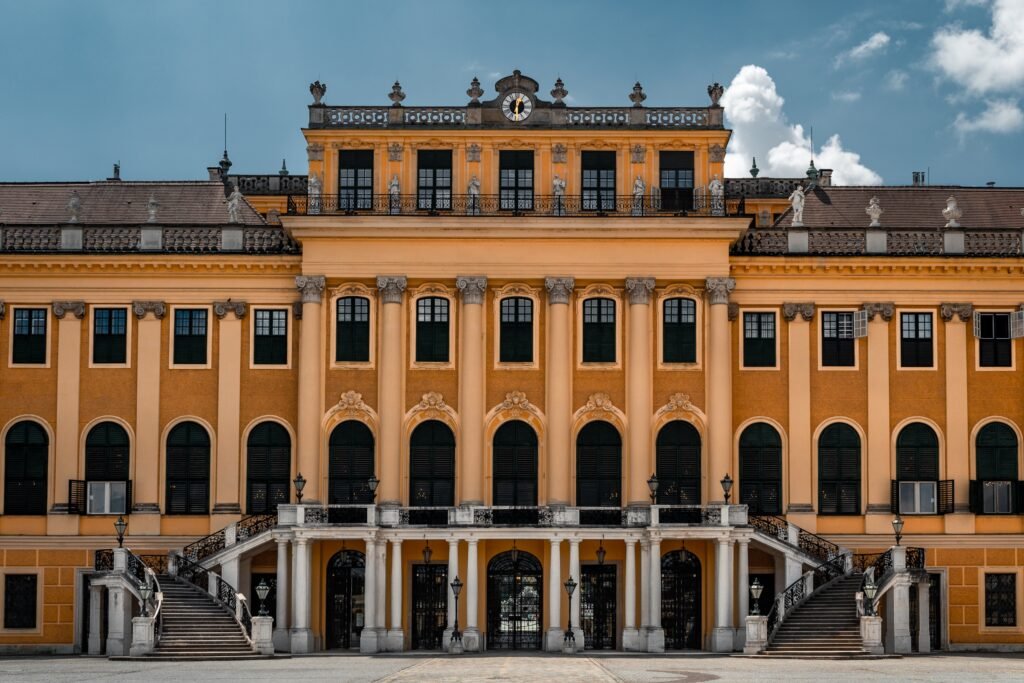 Ochre yellow and cream facade of Schonbrunn Palace in Vienna Austria