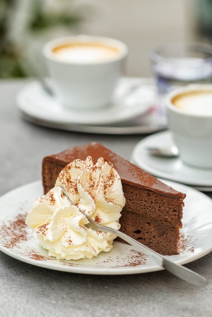 Traditional Viennese Sachertorte chocolate cake served with coffee