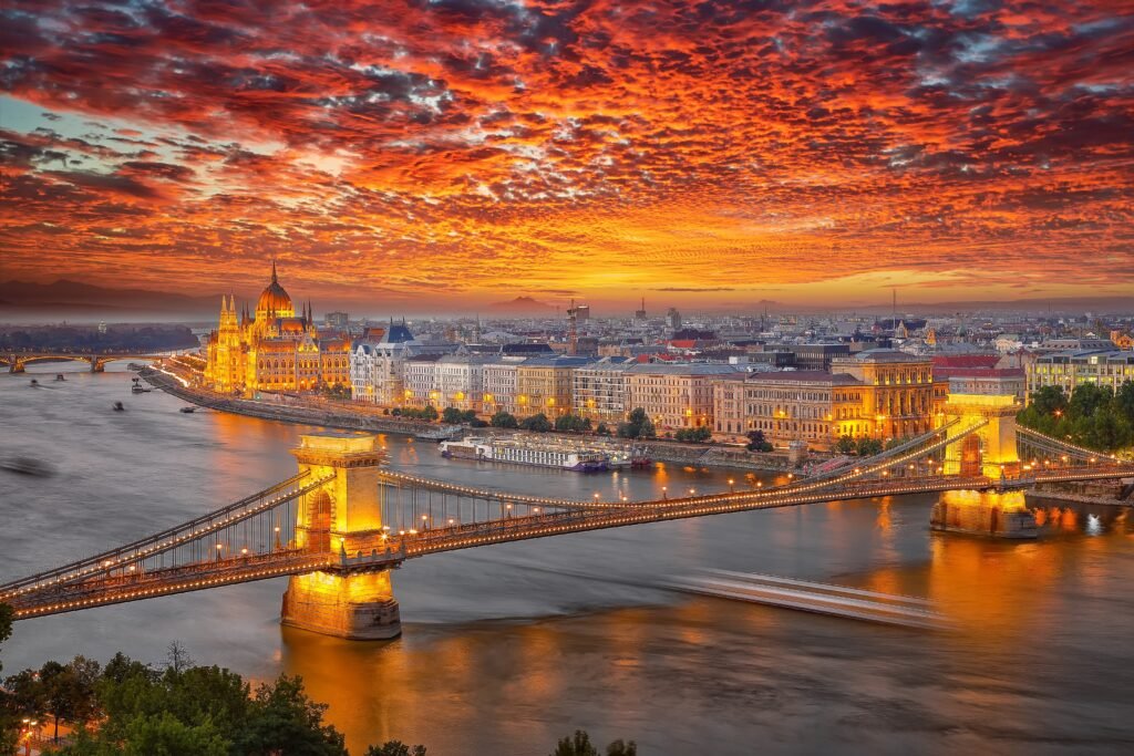 Budapest at night with the Hungarian Parliament and Chain Bridge illuminated beside the Danube River